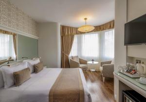 Postel nebo postele na pokoji v ubytování Hotel Yasmak Sultan