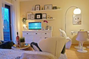 a living room with a tv sitting on a cabinet at Appartment Indira in Bad Sobernheim