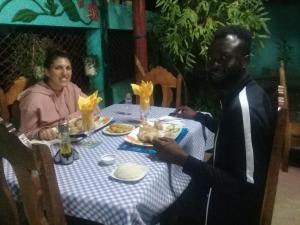 a man and a woman sitting at a table at Casa Orlairis y Chichi in Playa Larga