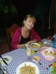 a girl sitting at a table with a plate of food at Casa Orlairis y Chichi in Playa Larga