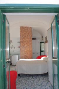 a bedroom with a bed and a brick wall at Attico del Cavaliere in Atrani