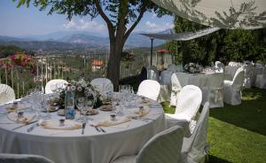 a table set up for a wedding with white tables and chairs at Chez Nous in Picinisco