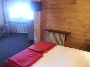 a bedroom with a bed and a lamp at Hôtel La Vanoise in Tignes