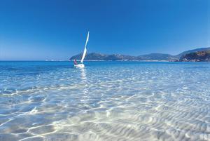 a sail boat in the middle of the water at Appartamento Deledda in Muravera