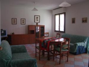 a living room with a table and chairs at Appartamento Deledda in Muravera