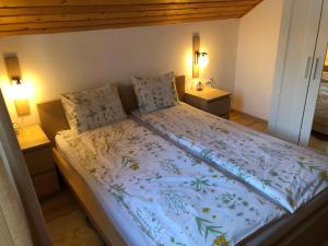 a bed in a room with two night stands at Casa de vacanta Mogosa in Baia-Sprie