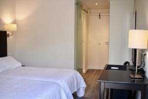Postel nebo postele na pokoji v ubytování Hostal Jakiton