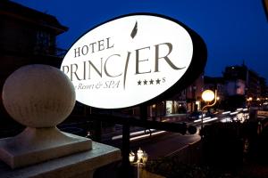 a sign for a hotel changer on a city street at Princier Fine Resort & SPA in Rimini