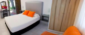 Postel nebo postele na pokoji v ubytování Hostal El Capi