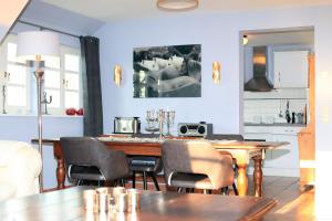 ein Esszimmer mit einem Holztisch und Stühlen in der Unterkunft Ferienwohnung im Blauen Haus in Ahrenshoop