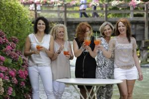 a group of women standing around a table holding drinks at Il Borghetto Vacanze nei Mulini in Valeggio sul Mincio