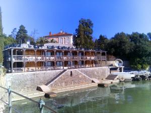a large building next to a body of water at Apartment LAUREL Center Opatija in Opatija