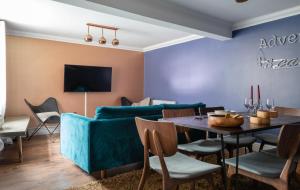 a living room with a blue couch and a table at The Historic Gem - Central 3BDR Maisonette in Oxford