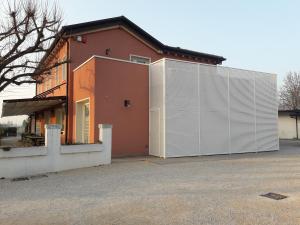 a large house with a white garage at Locanda Mirafiori in San Donà di Piave