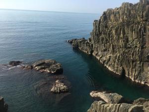 an aerial view of a rocky coastline with the ocean at Casa D'amore in Riomaggiore