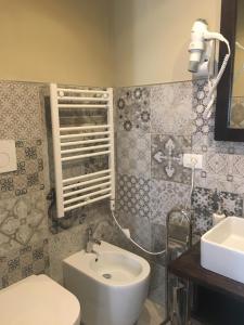 a bathroom with a white sink and a toilet at Casa D'amore in Riomaggiore