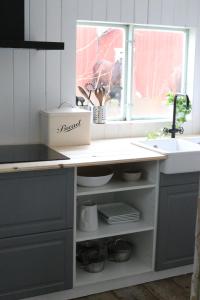 a kitchen with a sink and a counter top at Westergårds in Föglö +48 photos