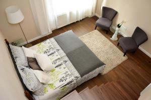 a bedroom with a bed with two chairs and a window at W35 in Budapest