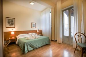 Postel nebo postele na pokoji v ubytování Hotel Duomo