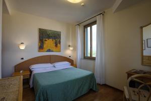 Postel nebo postele na pokoji v ubytování Hotel Duomo