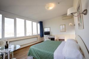 Postel nebo postele na pokoji v ubytování Hotel Duomo
