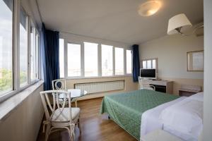 Postel nebo postele na pokoji v ubytování Hotel Duomo