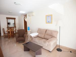 a living room with a couch and a table at Apartamentos Turísticos Spiritmar in Almerimar