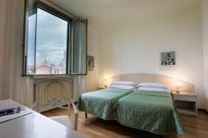 Postel nebo postele na pokoji v ubytování Hotel Duomo