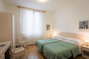 Postel nebo postele na pokoji v ubytování Hotel Duomo