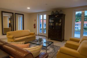 a living room with a couch and chairs and a table at Azoris Faial Garden – Resort Hotel in Horta