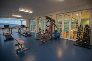 a gym with a view of the ocean in a house at Azoris Faial Garden – Resort Hotel in Horta