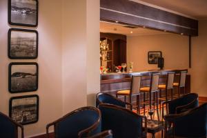 a bar with a bunch of chairs in a room at Azoris Faial Garden – Resort Hotel in Horta