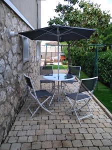 a table and two chairs and an umbrella on a patio at Villa Cottreau in Marseille