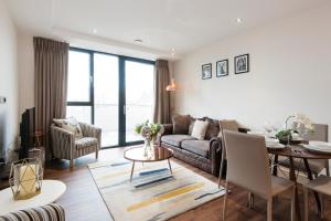 a living room with a couch and a table at Twyne House Apartments in London
