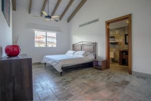 a bedroom with a bed and a ceiling fan at Balcones Beach Penthouse in Las Terrenas