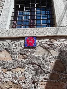 a brick wall with a painting of a heart on it at Palazzo Pisani Residenza Storica Pollica in Pollica