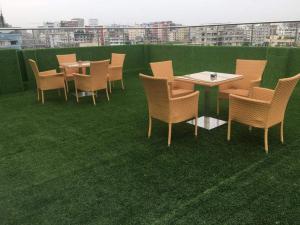 a group of chairs and tables on a lawn at Days Hotel Dhaka in Dhaka