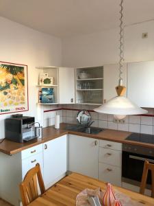 a kitchen with white cabinets and a stove top oven at De Isenboner Wankendorf in Wankendorf