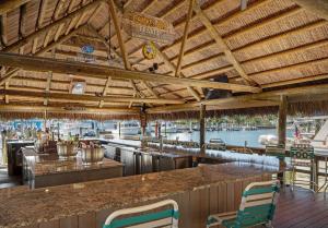 a bar with a view of a marina at Cove Inn on Naples Bay in Naples