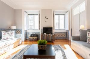 uma sala de estar com um sofá e uma mesa em Camoes by Central Hill Apartments em Lisboa