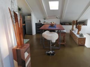 a kitchen with a table with a stool and a kitchen at Naiadi Loft Apartment in Nerezine
