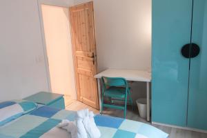 a bedroom with a bed and a desk and a chair at Koper2stay in Koper