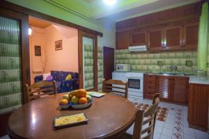 a kitchen with a table with a bowl of fruit on it at Retro Chic Apartment in Argostoli