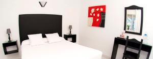 Postel nebo postele na pokoji v ubytování Hostal El Capi