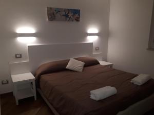 a bedroom with a large bed with two night stands at Hotel Il Pirata in Cinisi