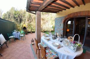 a patio with a table and chairs and a fireplace at Casa Milena in Massa