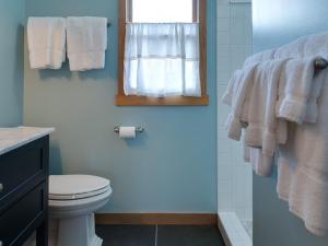a bathroom with a toilet and a window and towels at River Bluff Farm Bed and Breakfast in Quicksburg +29 photos
