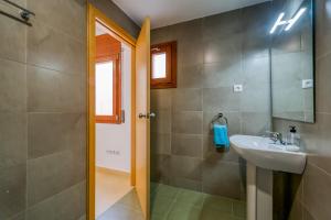 a bathroom with a sink and a shower at Vivalidays Urban Tossa House in Tossa de Mar