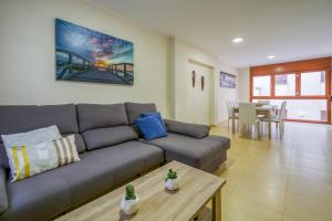a living room with a couch and a table at Vivalidays Urban Tossa House in Tossa de Mar