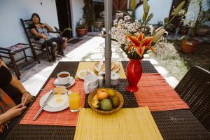 a table with a bowl of fruit and a plate of food at Gringo Bill's Cusco in Cusco